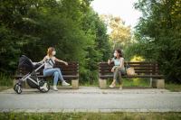 photo of two masked women sitting on park benches six feet apart, from Getty Images